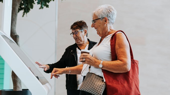 Ladies using touch screen at citizen service center